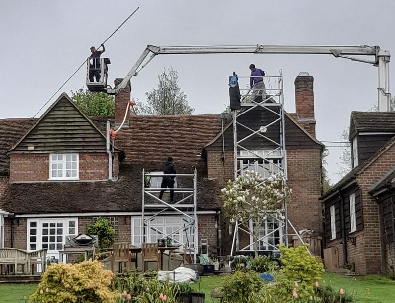The Moss Cleaners using cherry picker and scaffolding to clean roof safely and professionally in Chalford, Gloucestershire